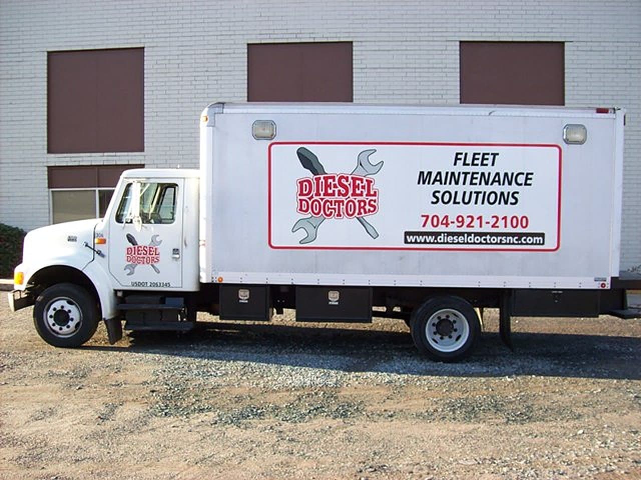 A Diesel Doctors box truck parked outside the shop