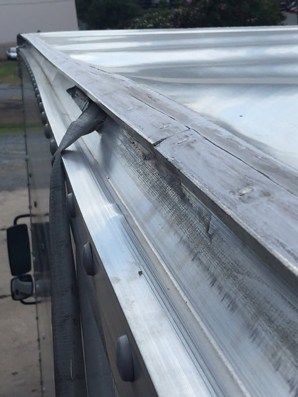 A damaged trailer top rail
